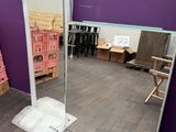 a mirror in the middle of a room with a purple wall