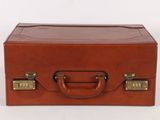brown leather suitcase sitting on a white surface with a white background