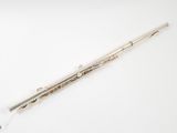 a silver flute on a white surface with a white background