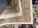 a close up of a rug on a table next to a wall