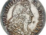 a silver coin with a woman ' s head and a crown on it