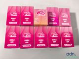 six boxes of pink condoms sitting on top of a white table