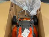 a box with a lawn mower in it on a table