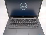 the dell laptop is open and ready to be used on the desk