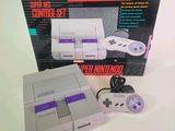 a nintendo classic game system with a controller and a box