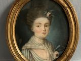 portrait of a lady with a flower in her hair in a gold frame