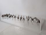 a display of various animal figurines on a clear shelf