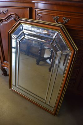 a mirror sitting on the floor next to a dresser
