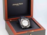 a wooden box with a watch inside of it