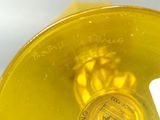 a close up of a yellow cup with a label on it