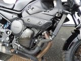 a close up of a motorcycle parked in a parking lot