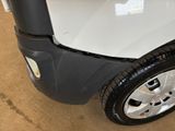 a close up of a white truck with a black tire