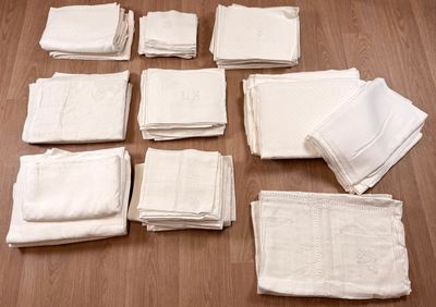 many white napkins laid out on a wooden floor
