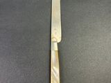 a close up of a knife sitting on top of a table