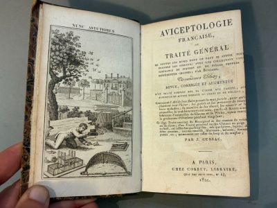 someone is holding a book with a picture of a man in a park