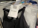 a black bra top and a yellow glove hanging on a rack