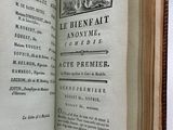 an open book with a picture of a town on it
