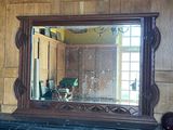 a mirror that is on a mantle in a room