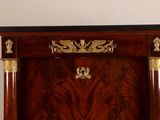 a wooden cabinet with a black top and gold accents