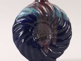 a blue and red vase sitting on a white surface