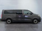 the grey van is parked on the concrete floor in the room