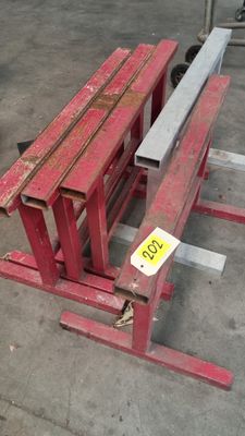 a red bench that is sitting in the middle of a parking lot