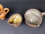 three different types of pottery sitting on a table