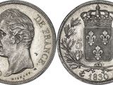 a silver coin with a crown on top of it