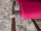 a close up of a chair with a red cover on it