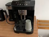 a small coffee maker on a small table in a room