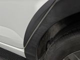 a close up of a tire on the side of a white truck