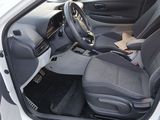 the interior of a car with the door open and the driver ' s seat up