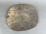a piece of wood with a green dot on it