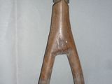 a wooden sculpture of a horse ' s head on a shelf