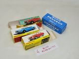 three boxes of toy cars sitting on a table