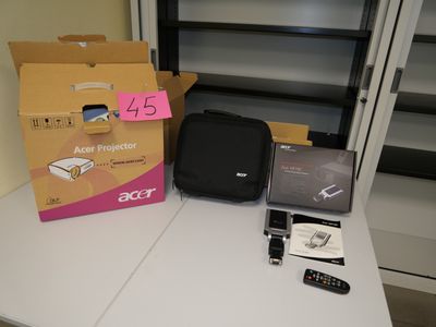 a table with a laptop, a cell phone, and other items on it