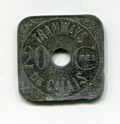 a small metal coin with a hole in the middle