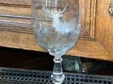 a wine glass sitting on a table near a door