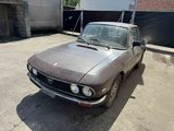 an old car that is parked in a lot
