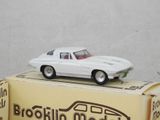 a white toy car sitting on top of a box
