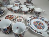 a table with a lot of different plates and cups and saucers