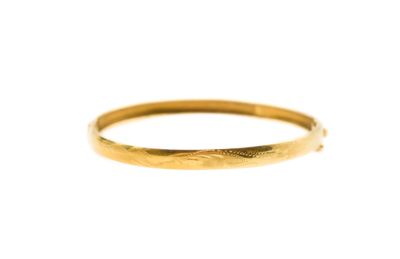 a close up of a gold ring on a white background
