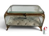 a glass box with a cushion on top of it