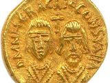 a close up of a gold coin with two people on it