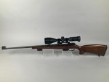 a rifle with a scope and a scope scope on it