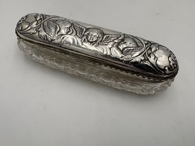 silver plated box with flowers and leaves on it on a white surface