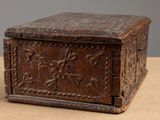 an old wooden box sitting on top of a table next to a wall