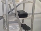 a metal shelf that has a lot of boxes on it