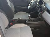 the interior of a car with the door open and the driver ' s seat down