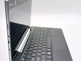a laptop with a keyboard on it sitting on a table